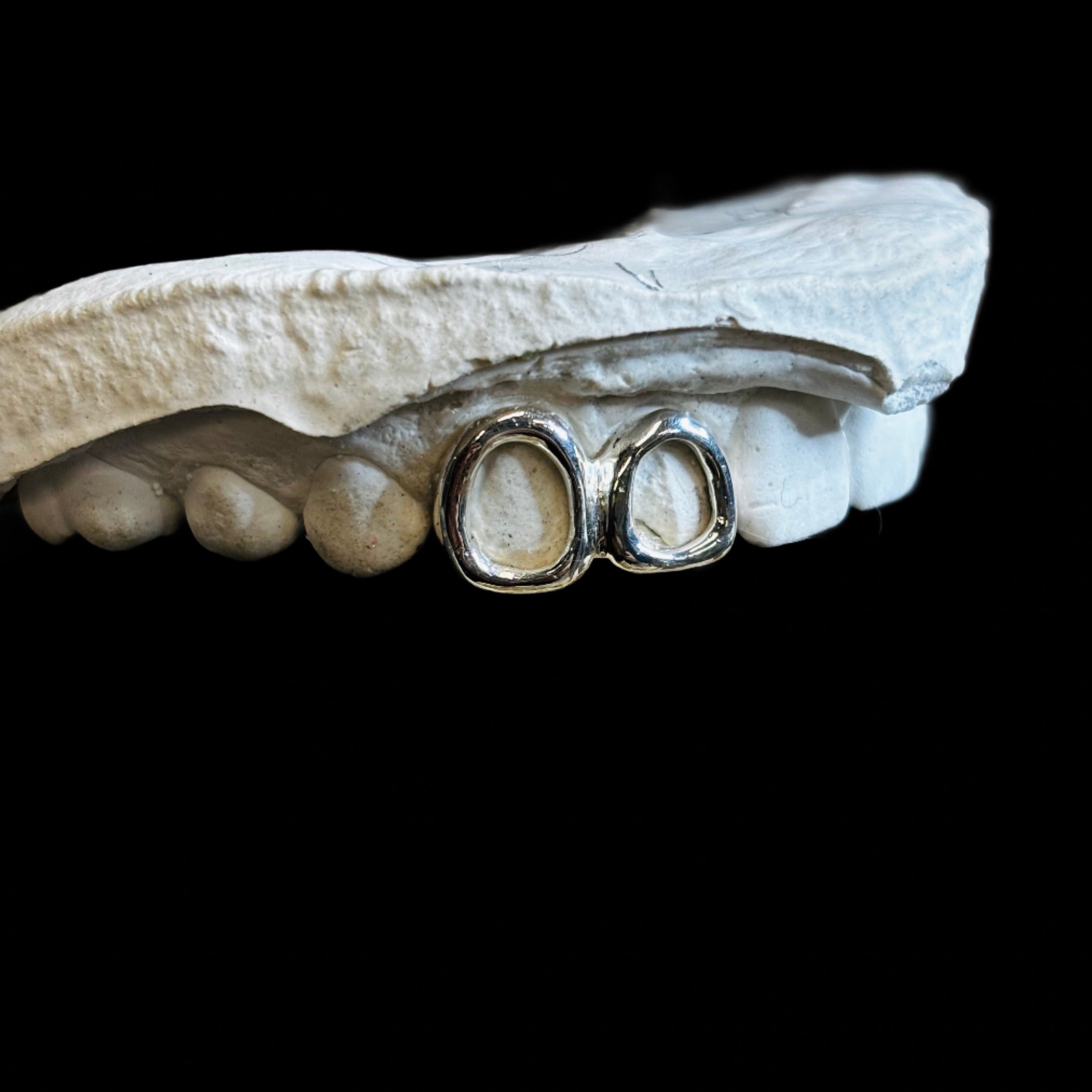 Two teeth in Stg Silver, frames